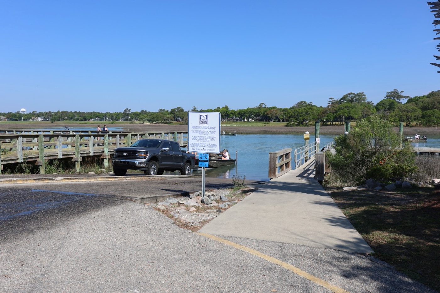 Active boat ramp at Cherry Grove Park with truck launching boat