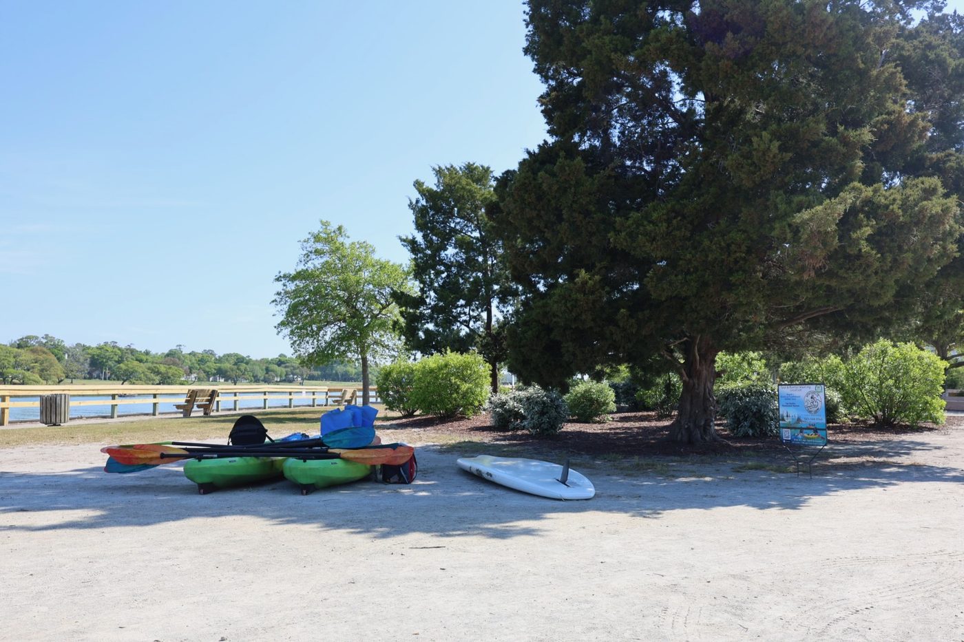 Kayaks and paddleboard staged near the water at Cherry Grove Park