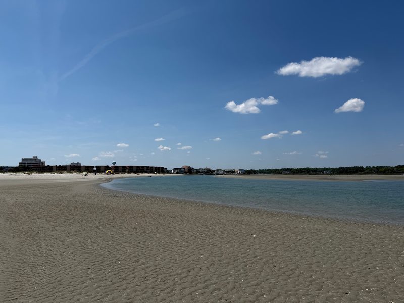 The Cherry Grove Inlet at low tide from The Point — calm water, exposed sandbar