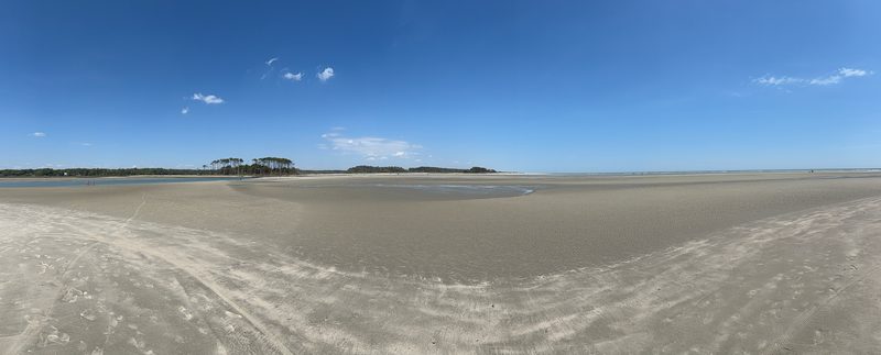 Panoramic view of The Point at Cherry Grove Beach at low tide — sandbar and inlet